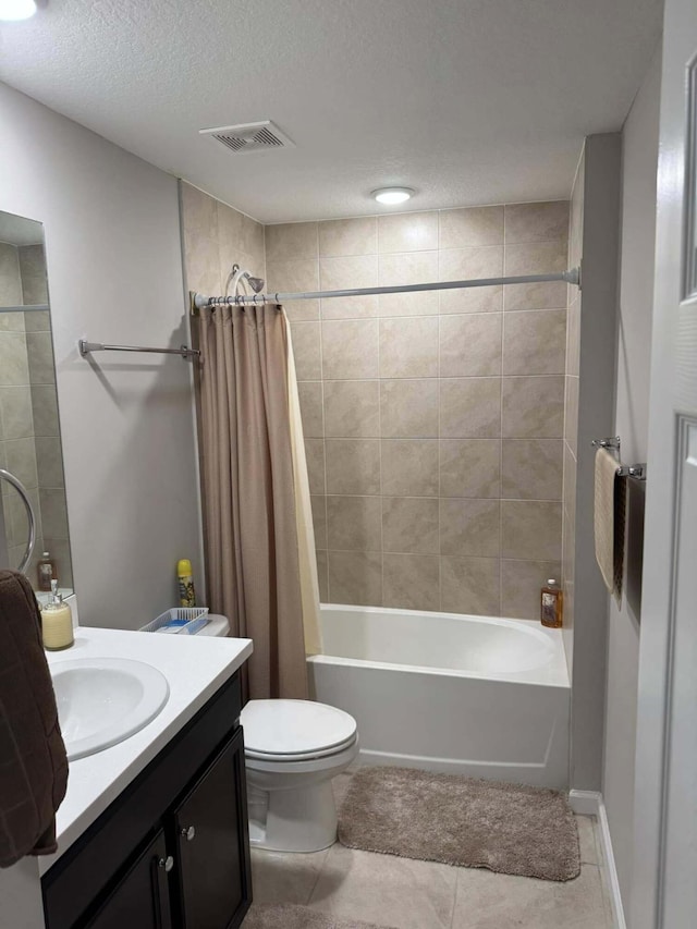 bathroom featuring a textured ceiling, vanity, visible vents, shower / tub combo, and tile patterned floors