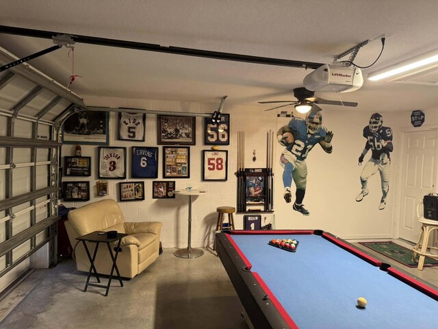 rec room with a garage, concrete floors, and a ceiling fan