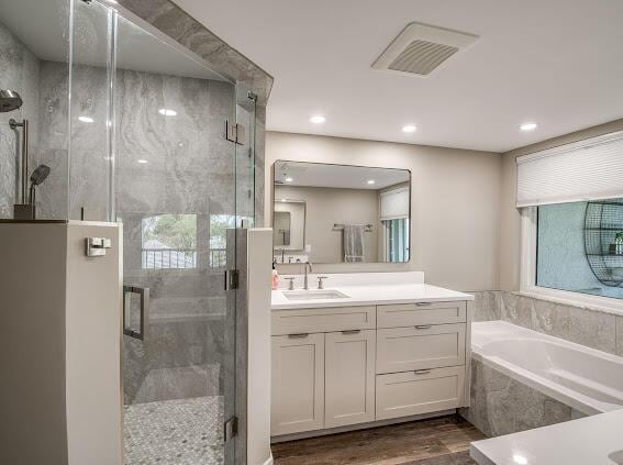 1000 N US Highway 1 Unit 656, Jupiter, FL 33477 - bathroom featuring vanity, a shower stall, visible vents, a garden tub, and wood finished floors