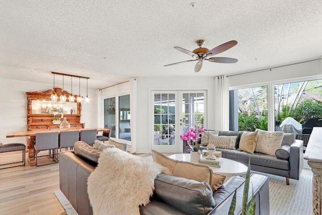 1000 N US Highway 1 Unit 656, Jupiter, FL 33477 - living area featuring a wealth of natural light, light wood finished floors, ceiling fan, and a textured ceiling