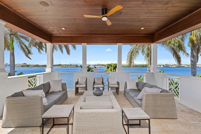 view of patio with ceiling fan, an outdoor hangout area, and a water view