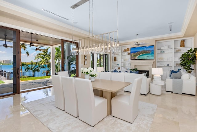 dining area with ornamental molding, a fireplace, marble finish floor, and ceiling fan
