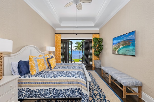 bedroom featuring crown molding, wood finished floors, ceiling fan, a raised ceiling, and access to outside