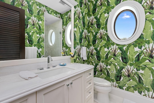bathroom featuring wallpapered walls, visible vents, toilet, vanity, and tiled shower