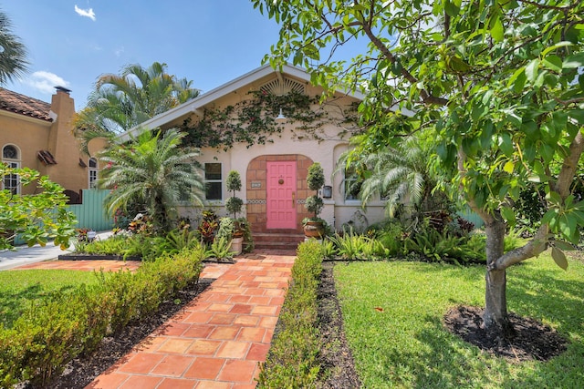 426 30th St, West Palm Beach, FL 33407 - view of front of home featuring fence and stucco siding