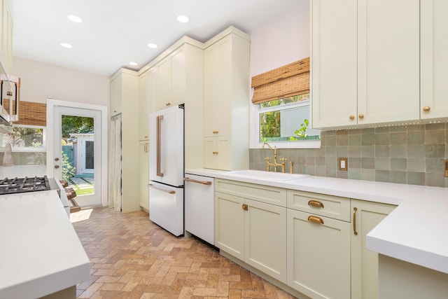 426 30th St, West Palm Beach, FL 33407 - kitchen featuring a sink, white appliances, light countertops, tasteful backsplash, and recessed lighting