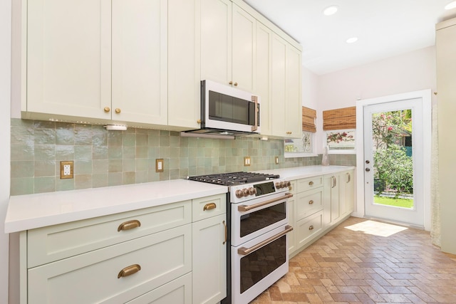 426 30th St, West Palm Beach, FL 33407 - kitchen with a healthy amount of sunlight, light countertops, and decorative backsplash