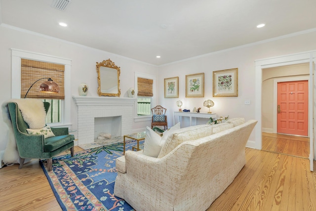 426 30th St, West Palm Beach, FL 33407 - living room with light wood finished floors, crown molding, visible vents, and recessed lighting