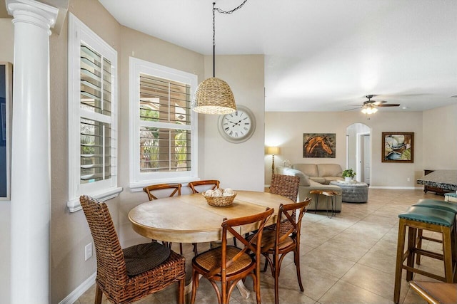 2999 Dovedale Ct, Wellington, FL 33414 - dining room featuring ornate columns, baseboards, ceiling fan, arched walkways, and light tile patterned floors