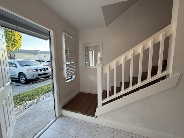 tiled foyer entrance featuring baseboards