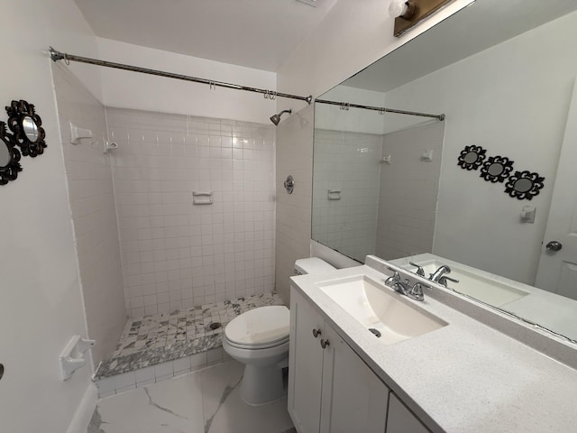 bathroom with vanity, a tile shower, marble finish floor, and toilet
