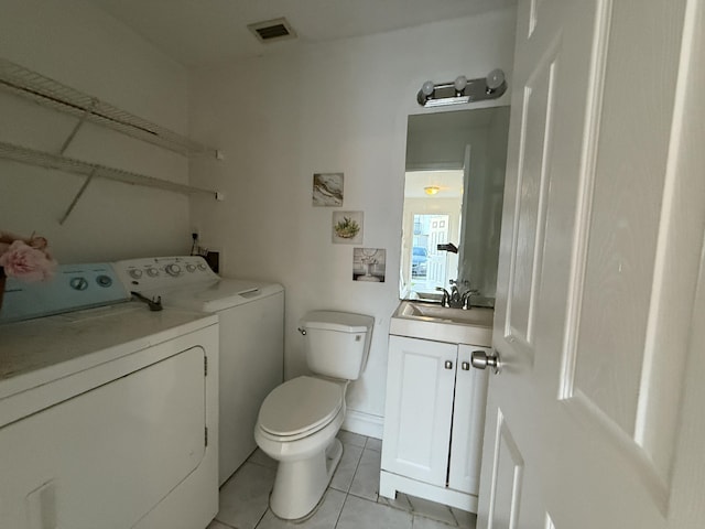bathroom featuring tile patterned floors, toilet, visible vents, separate washer and dryer, and vanity