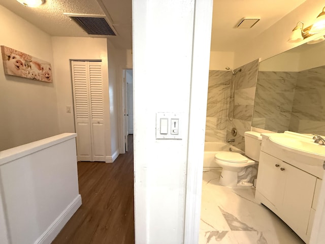 bathroom featuring shower / bathing tub combination, visible vents, toilet, and vanity