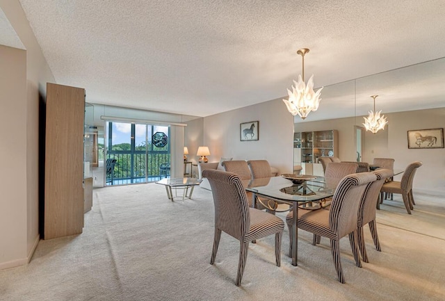 dining room featuring light carpet, a notable chandelier, and a textured ceiling
