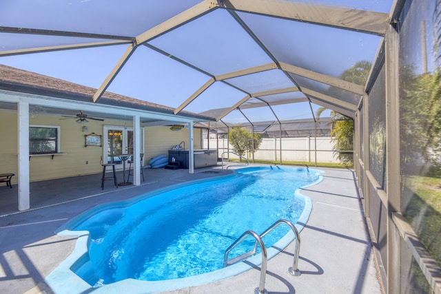 view of swimming pool featuring glass enclosure, a patio area, a fenced in pool, fence, and a hot tub