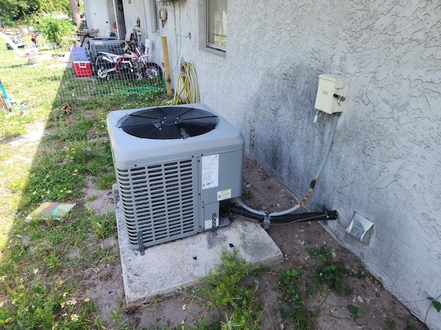 exterior details featuring stucco siding and central AC unit