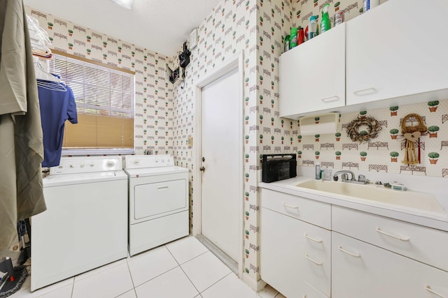 2502 NW 66th Dr, Boca Raton, FL 33496 - laundry room with washing machine and clothes dryer, wallpapered walls, light tile patterned floors, cabinet space, and a sink