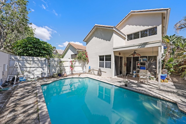 2502 NW 66th Dr, Boca Raton, FL 33496 - rear view of property featuring a ceiling fan, fence, stucco siding, a tiled roof, and a patio area