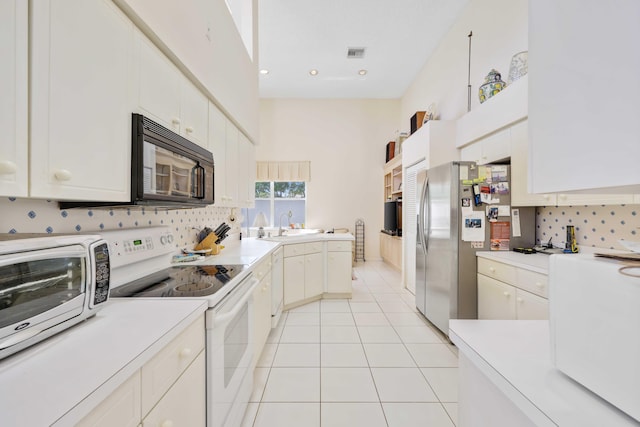 2502 NW 66th Dr, Boca Raton, FL 33496 - kitchen featuring tasteful backsplash, visible vents, light countertops, light tile patterned flooring, and white appliances