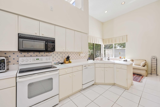 2502 NW 66th Dr, Boca Raton, FL 33496 - kitchen with a sink, white appliances, a peninsula, and light countertops