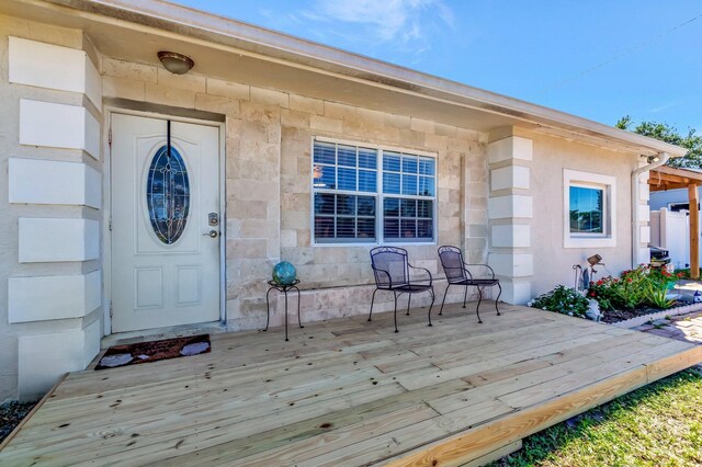 doorway to property featuring stone siding