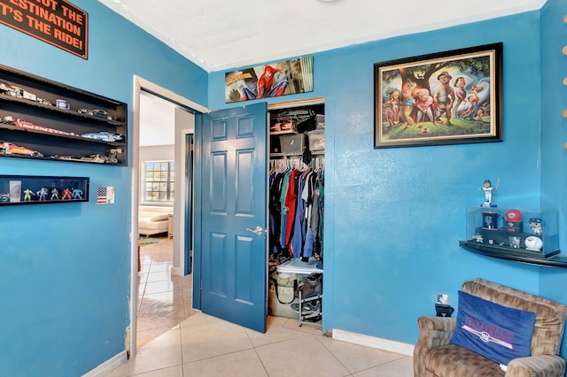 hall featuring tile patterned floors and baseboards
