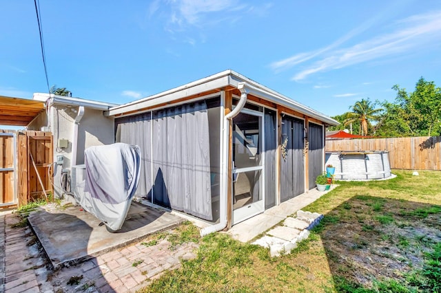 view of outbuilding featuring a swimming pool, an outbuilding, and a fenced backyard
