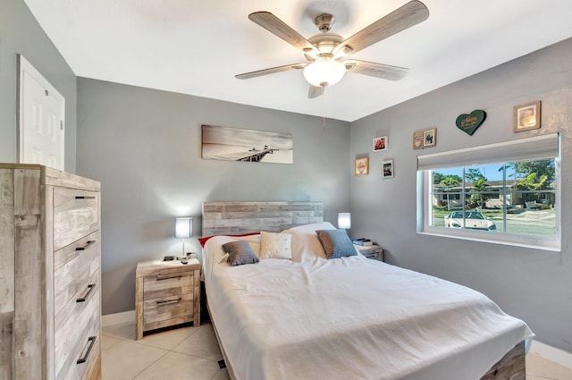 bedroom with light tile patterned floors, baseboards, and ceiling fan