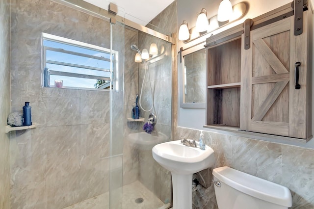 bathroom featuring toilet, tile walls, and a shower stall
