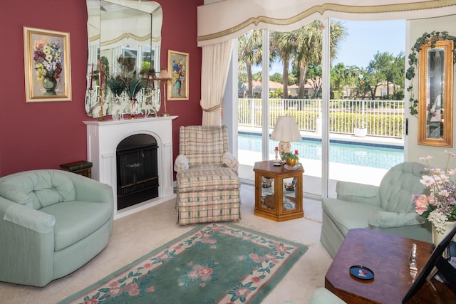 living area with carpet floors and a fireplace