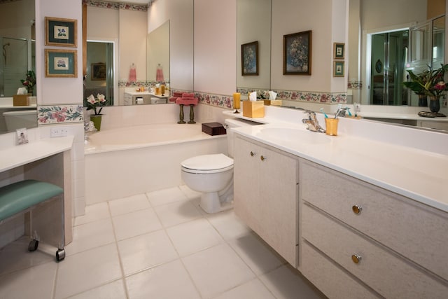 full bathroom with a bath, tile patterned floors, vanity, and toilet