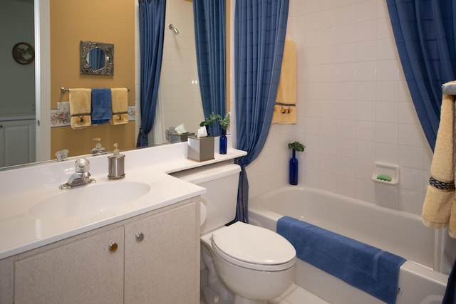 full bathroom featuring shower / bath combination with curtain, vanity, and toilet