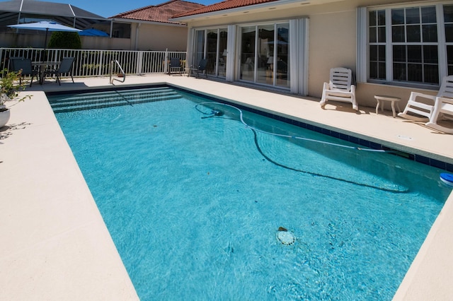 view of pool with a fenced in pool, a patio area, and fence