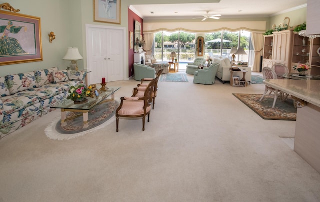 carpeted living area featuring ceiling fan and ornamental molding