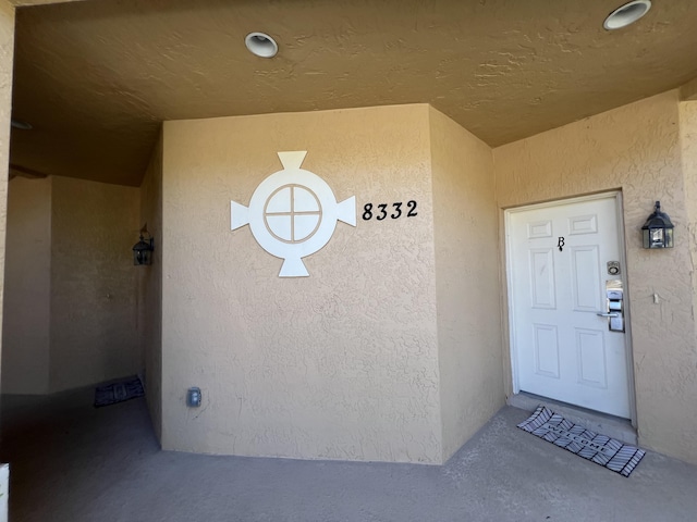 view of exterior entry with stucco siding