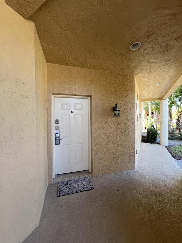 property entrance with stucco siding