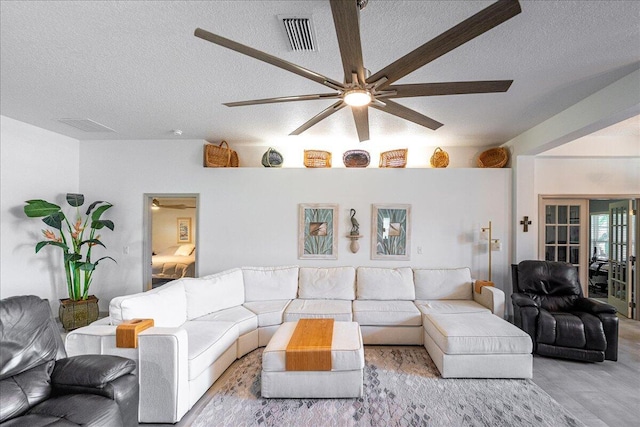 5879 NW Leah Dr, Port Saint Lucie, FL 34986 - living area with a textured ceiling, wood finished floors, and a ceiling fan