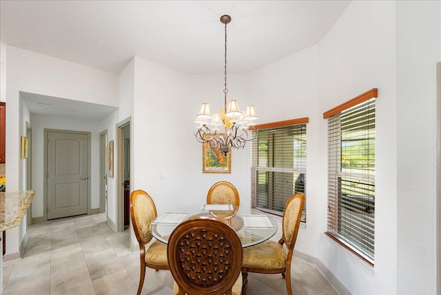 5879 NW Leah Dr, Port Saint Lucie, FL 34986 - dining room featuring a chandelier and baseboards