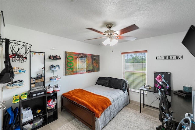 5879 NW Leah Dr, Port Saint Lucie, FL 34986 - bedroom featuring a textured ceiling, ceiling fan, and light tile patterned floors