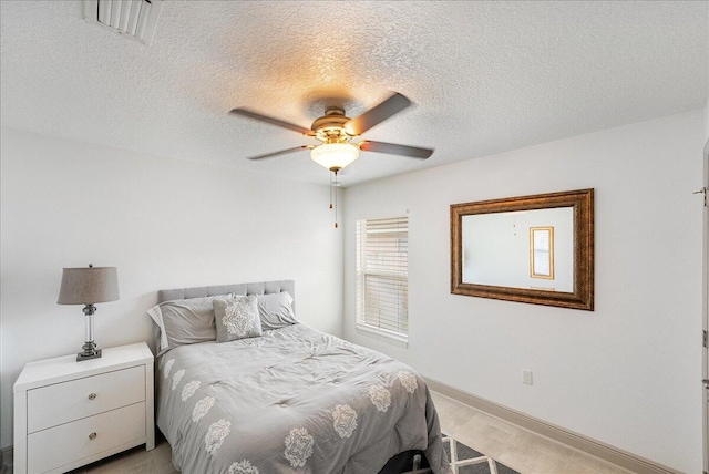 5879 NW Leah Dr, Port Saint Lucie, FL 34986 - bedroom featuring a textured ceiling, baseboards, and ceiling fan
