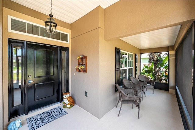 5879 NW Leah Dr, Port Saint Lucie, FL 34986 - entrance to property featuring a porch and stucco siding