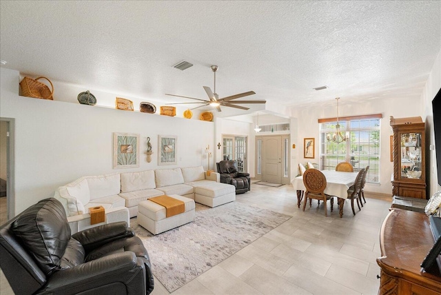 5879 NW Leah Dr, Port Saint Lucie, FL 34986 - living room with a chandelier, a textured ceiling, and ceiling fan