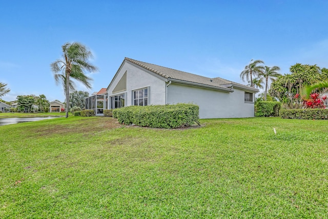 6308 Crystal View Ln, Boynton Beach, FL 33437 - view of side of home featuring a yard, a water view, a tile roof, stucco siding, and a lanai