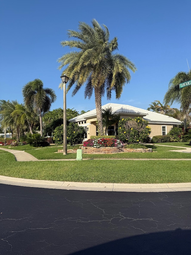 6308 Crystal View Ln, Boynton Beach, FL 33437 - view of front of house with a front yard, stucco siding, and a tile roof