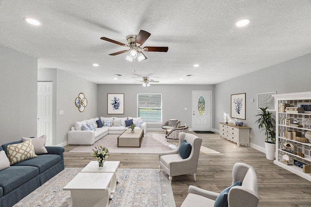 2244 Cooks Ct, Vero Beach, FL 32962 - living area with ceiling fan, a textured ceiling, baseboards, wood finished floors, and recessed lighting