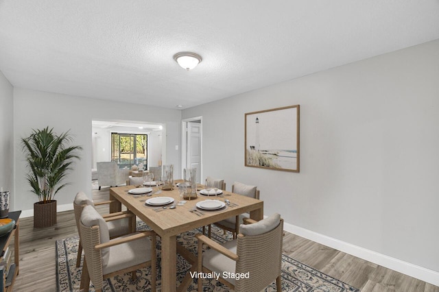 2244 Cooks Ct, Vero Beach, FL 32962 - dining space featuring light wood finished floors, baseboards, and a textured ceiling