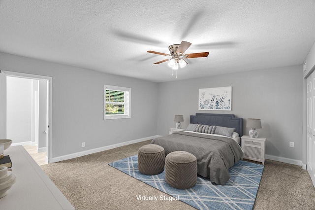 2244 Cooks Ct, Vero Beach, FL 32962 - bedroom with carpet flooring, a textured ceiling, baseboards, and a ceiling fan