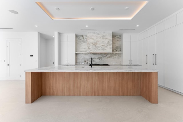 880 NE 3rd Ave, Boca Raton, FL 33432 - kitchen with modern cabinets, a spacious island, light stone countertops, white cabinets, and recessed lighting