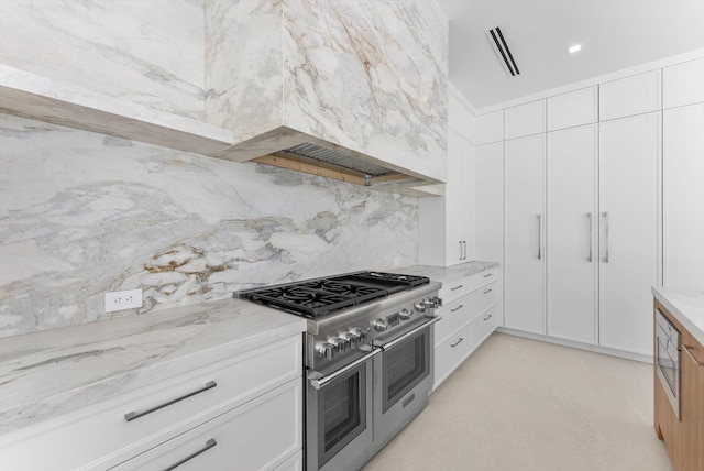 880 NE 3rd Ave, Boca Raton, FL 33432 - kitchen featuring appliances with stainless steel finishes, decorative backsplash, white cabinets, and light stone counters