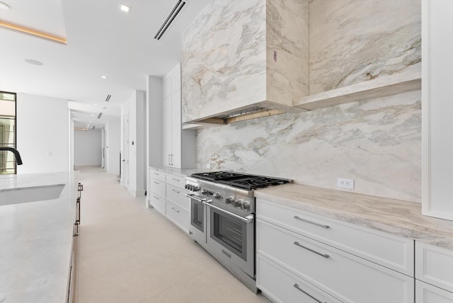880 NE 3rd Ave, Boca Raton, FL 33432 - kitchen featuring range with two ovens, a sink, white cabinetry, tasteful backsplash, and light stone counters